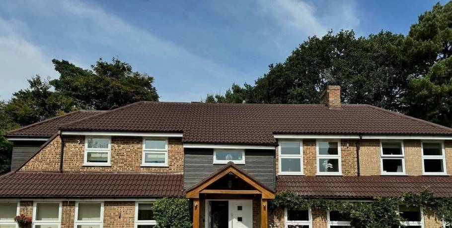 Fully restored and freshly coated house roof after expert roof spraying and painting service in Central Scotland